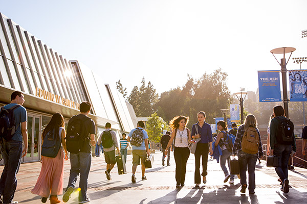 Students on Bruin Walk pass the north entrance to Pauley Pavilion. Photo by Coral Von Zumwalt