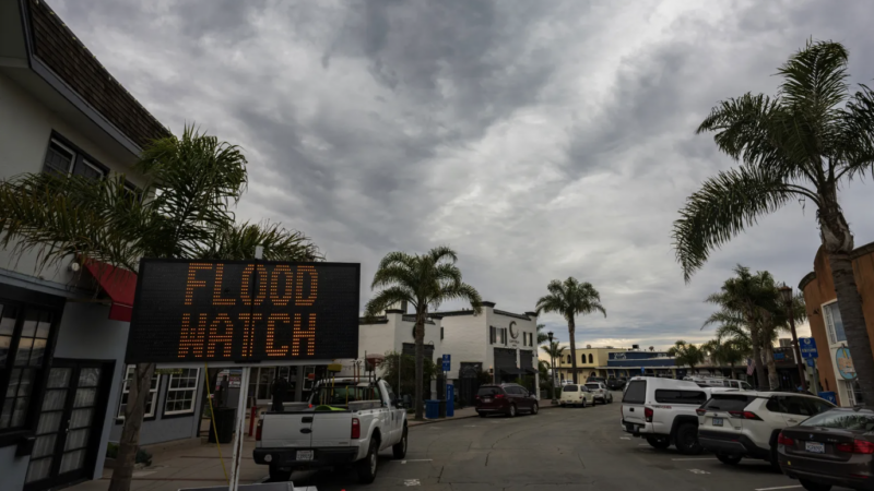 A sign warns of potential flooding in Capitola Village Wednesday, Jan. 31, 2024, in Capitola, Calif. An atmospheric river is set to make its way into Northern California, bringing warnings of heavy rain, possible flooding and high winds.(AP Photo/Nic Coury)