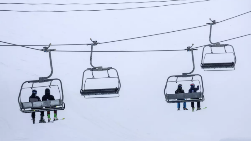 Skiers ride a chair lift on a blustery day at Mammoth Mountain on March 14 in Mammoth Lakes. (Brian van der Brug / Los Angeles Times)