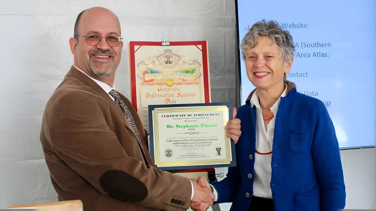 Caption: Steven Steinberg, L.A. County’s Geographic Information Officer, presents Pincetl with an award at the county’s 17th annual GIS Day