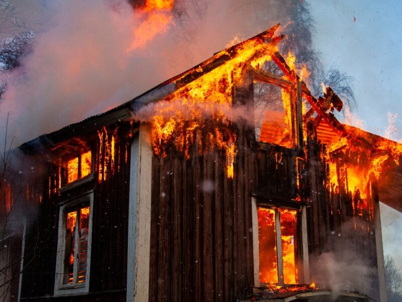 Old wooden house on fire by Mattias Bokinge, Canva