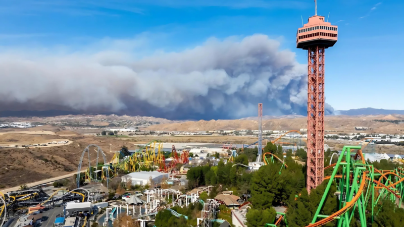 The Hughes Fire burns behind the skyline of Six Flags Magic Mountain, in Valencia, Calif., on Thursday.Brandon Bell / Getty Images